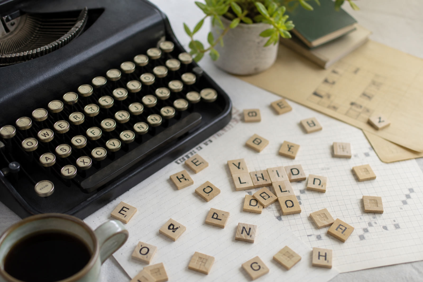 Typewriter keys and letter tiles on paper